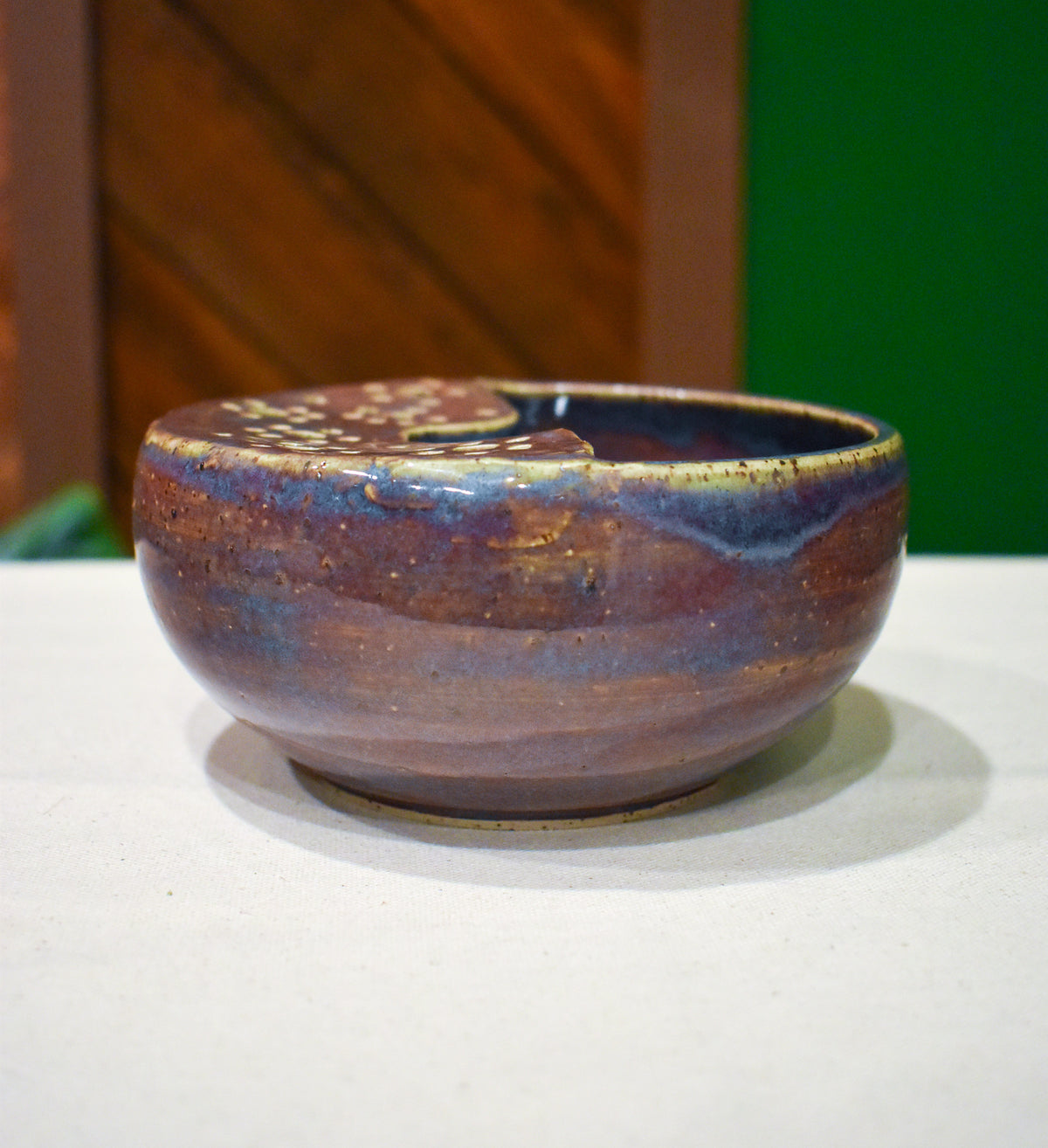 Hand-thrown ceramic berry bowl with a hand-punched drain panel, in slate-blue and plum Elderberry