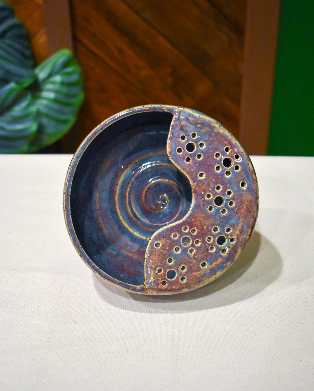 Hand-thrown ceramic berry bowl with a hand-punched drain panel, in slate-blue and plum Elderberry